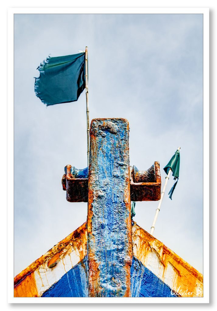 La majestueuse proue d&#039;un chalutier à la retraite, témoignage du temps, flanquée de deux drapeaux